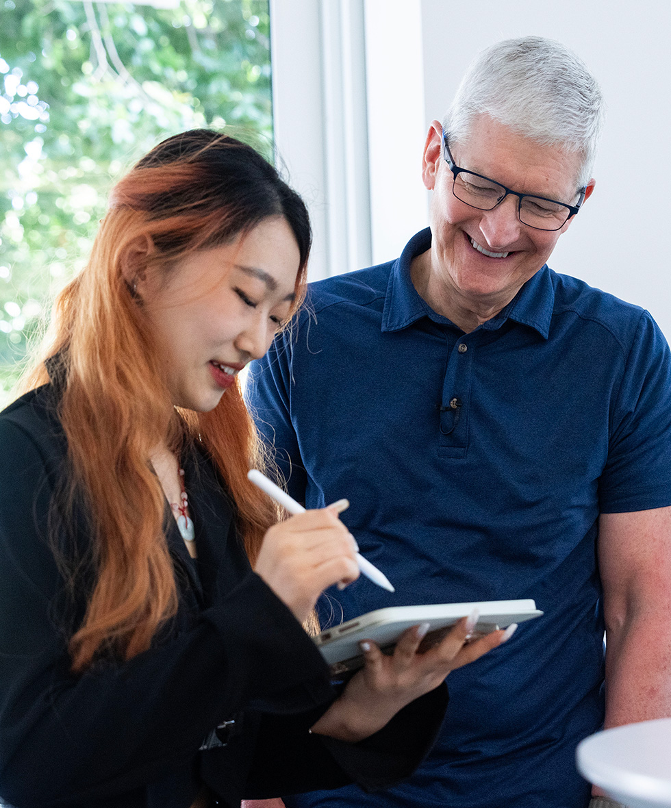 Distinguished Winner Ruoshan Li from China demonstrating Deep Blue Tangram on iPad to Tim Cook at WWDC at Apple Park